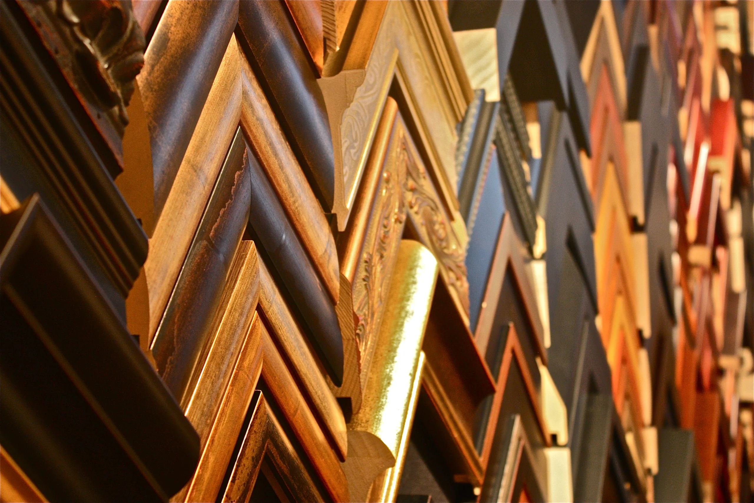 Picture frame corner samples in gold, wood and black finishes