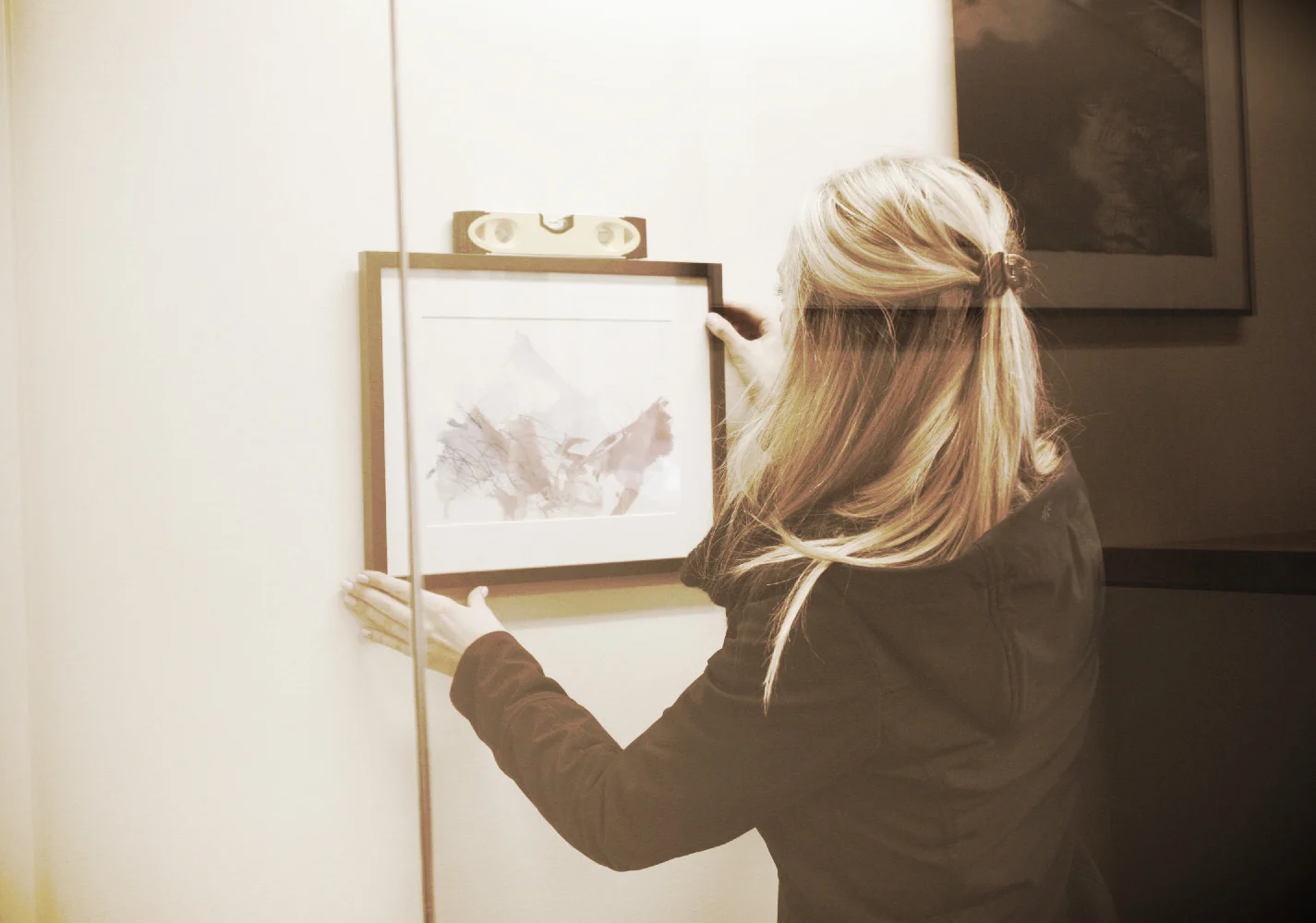 Hanging a framed artwork on an office wall